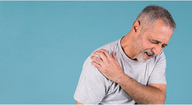Senior man experiencing shoulder pain, clutching his arm