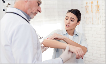 Doctor examining patient's arm rash