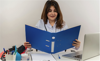 Doctor reviewing patient files at her desk