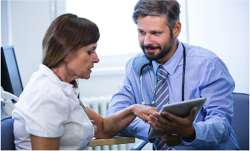 Doctor and patient reviewing medical records on a tablet